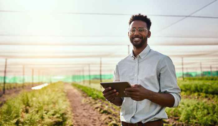 Cropped portrait of a handsome young male farmer using a tablet while working on his farm